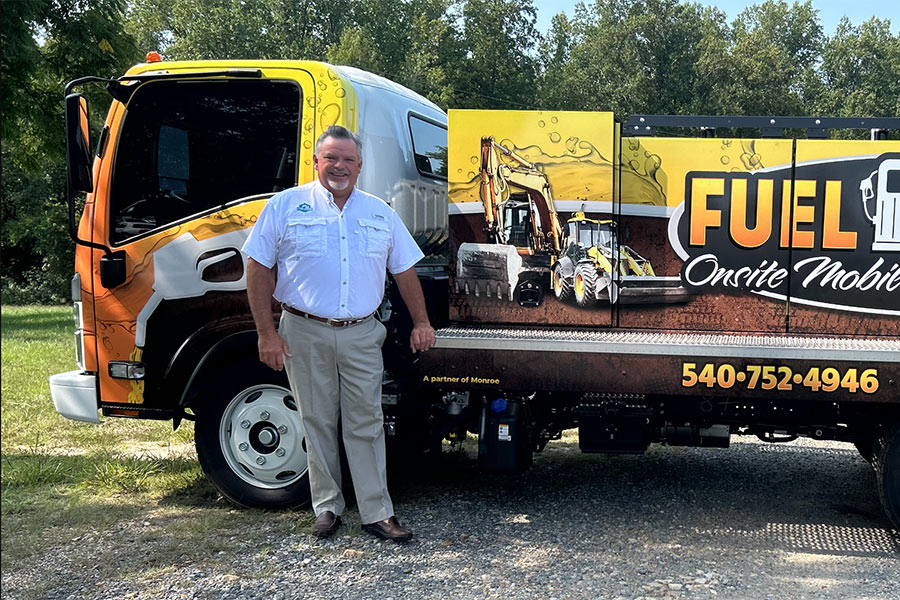 Photo of Joey Monroe standing next to Fuel Works mobile diesel delivery truck